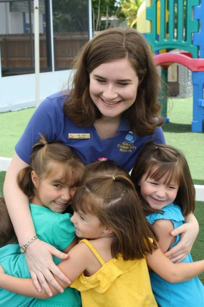 Smiling daycare teacher with children